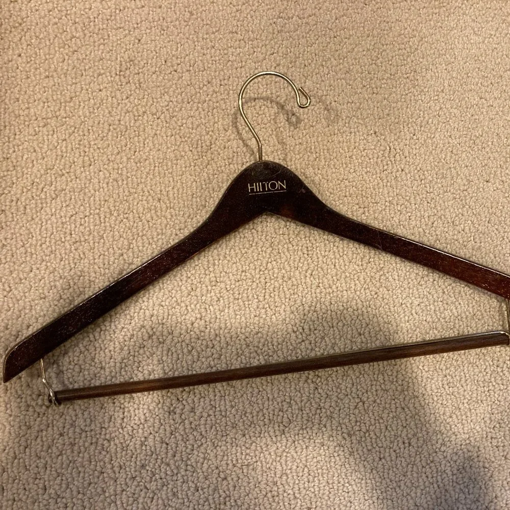 Vintage Hilton dark brown glossy wooden suit hanger. some scratches.